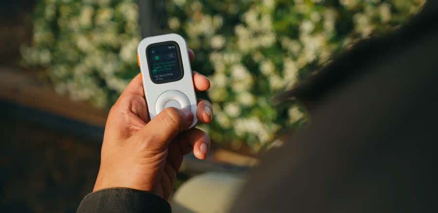 Person operating RePod C1 outdoors while a playlist is visible on Apple Watch