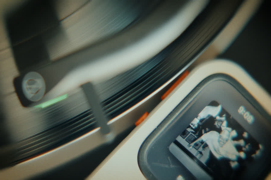 Front-facing RePod C1 with music playback visible on Apple Watch beside compact music players
