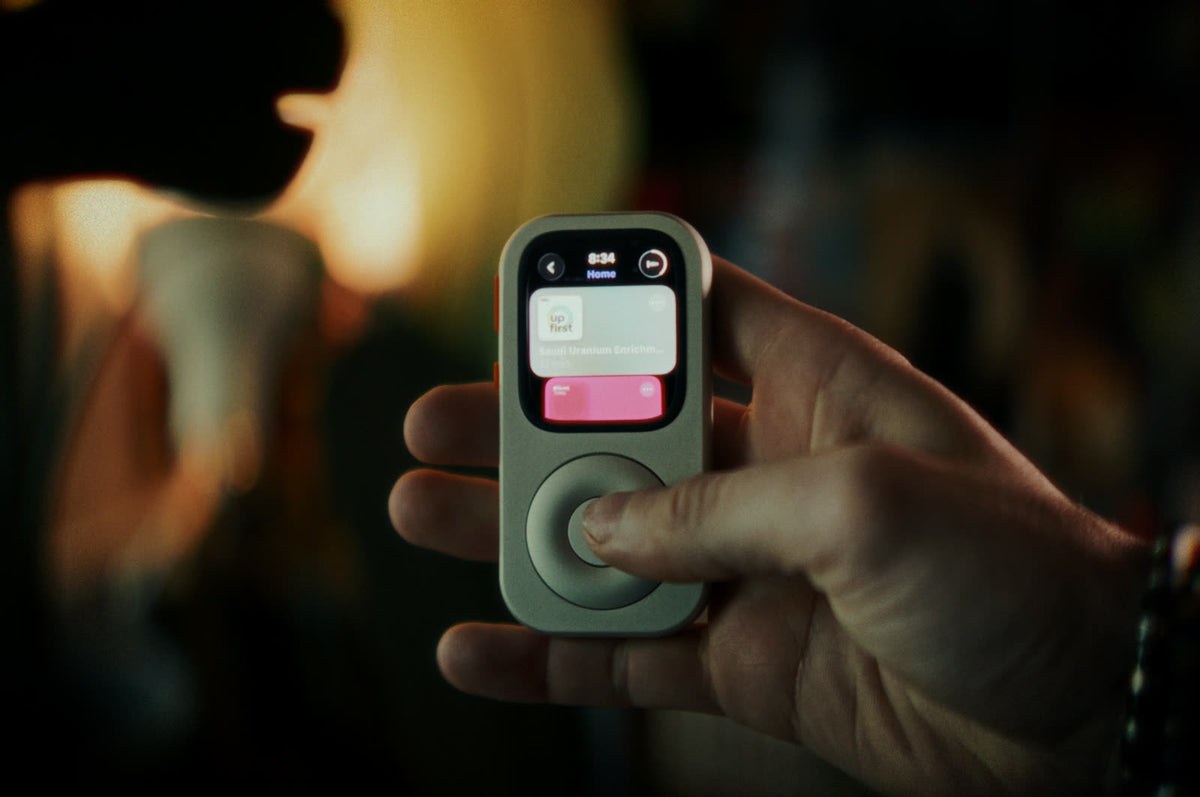 A front-facing RePod held in one hand with smart-home controls visible on the Apple Watch screen