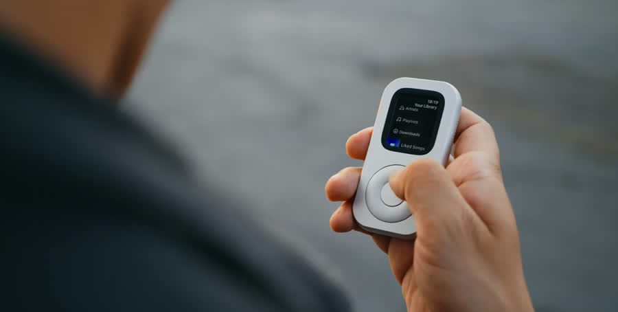A person holding RePod C1 while the Apple Watch shows music library and download options
